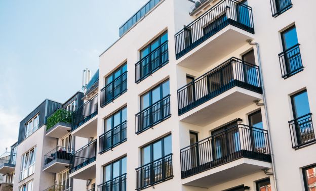 A modern multi-family unit with black balconies - Express Capital Financing
