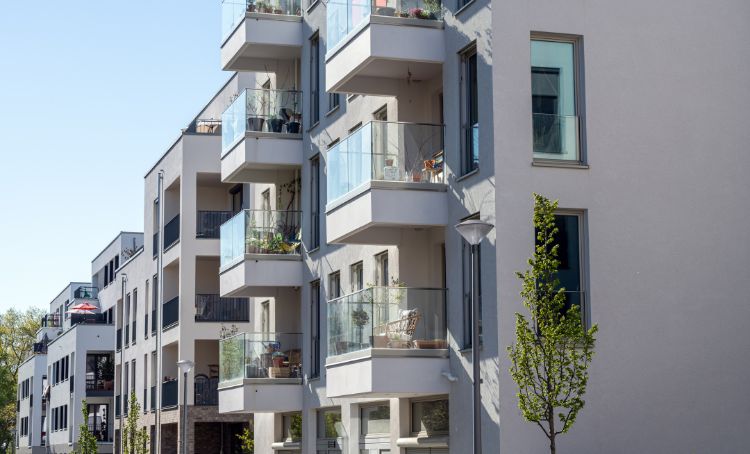 A multifamily apartment block on a sunny day - ECF