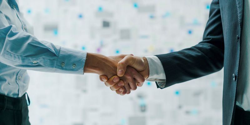 A NYC Business Loan lender shaking hands with a property investor - ECF