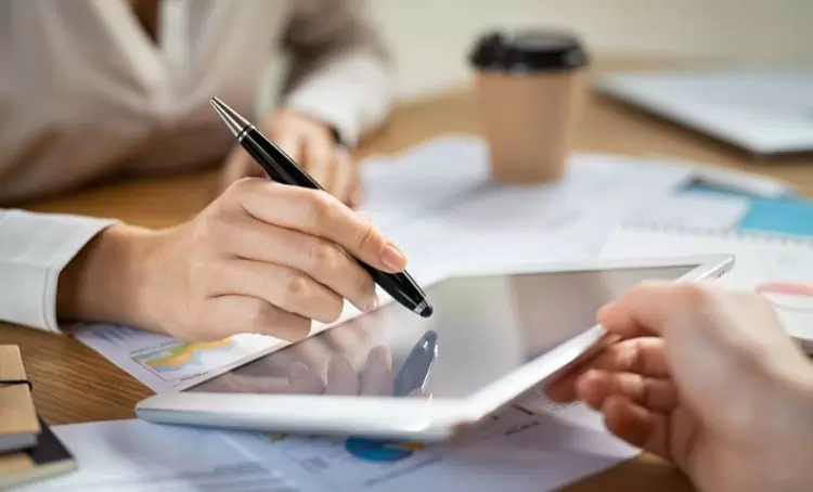 A property investor signing a digital contract - Real estate technology - Express Capital Financing