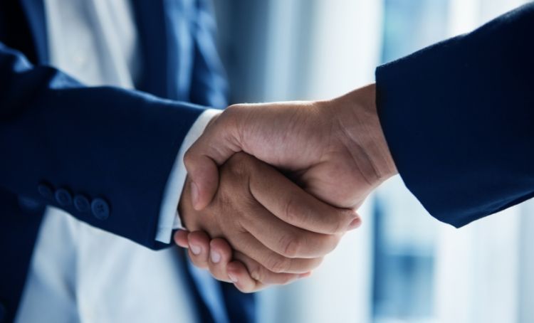 Two property investors shaking hands - Real Estate Technology - Express Capital Financing