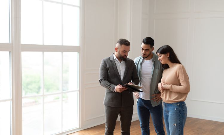 a couple discussing finance with a realtor - airbnb investment