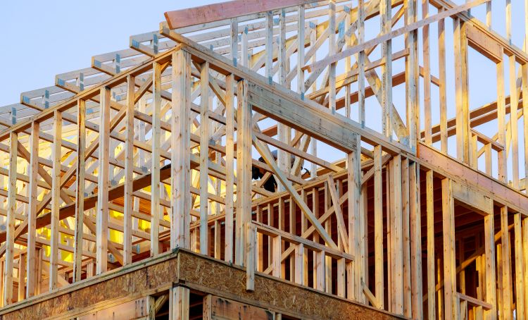 The timber frame of a new build property under construction - Financing a New Home Build - ECF