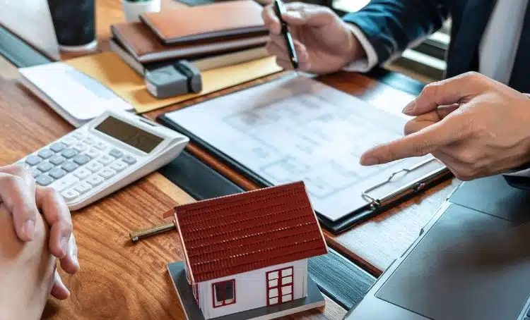 a contract in front of a small house - hard money lender