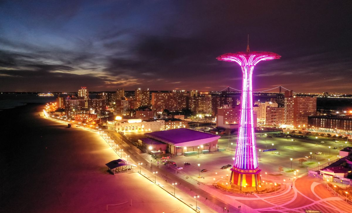 An ariel view of a fairground on Coney Island at night - Express Capital Financing