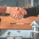 A property investor shaking on a DSCR loan agreement with Express Capital Finance