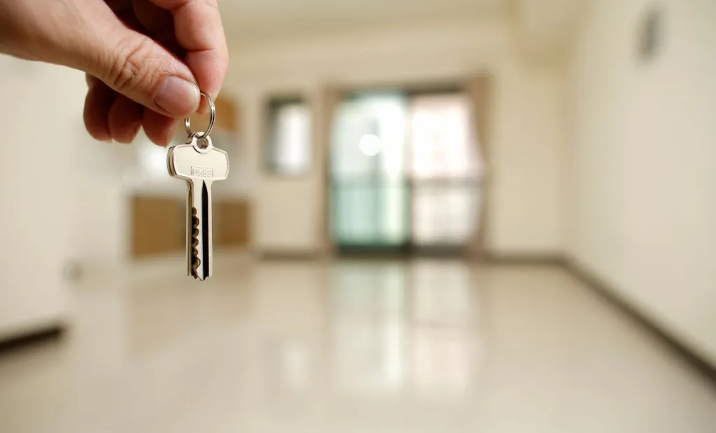 A property investor holding the keys to a rental property - Express Capital Finance