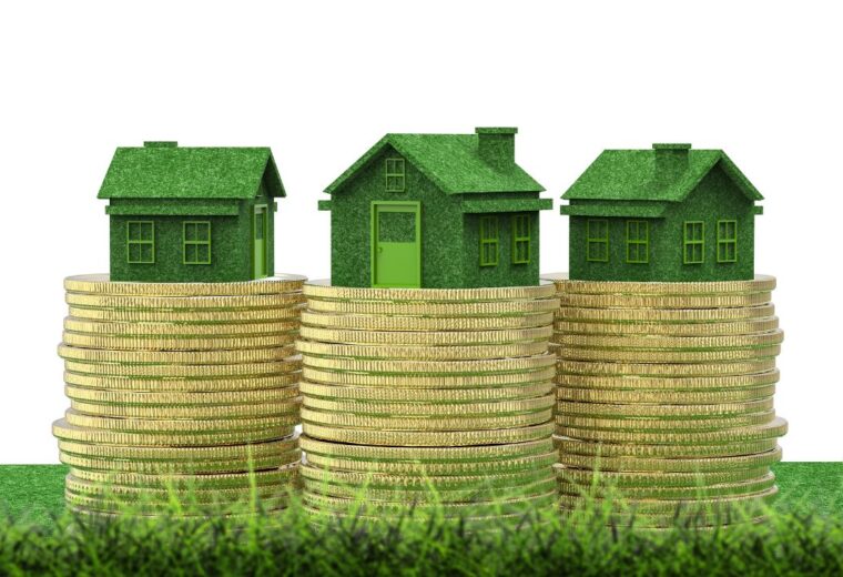 Three small models of houses sitting on top of three stacks of gold coins - Express Capital Financing