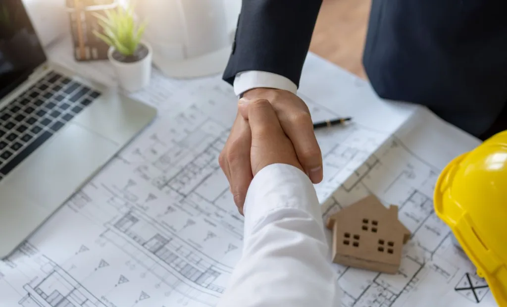 Hands over a blueprint for a property - Express Capital Financing