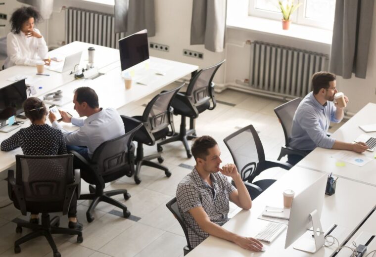 An overview shot of people sitting at desks in an open-plan office - Express Capital Financing