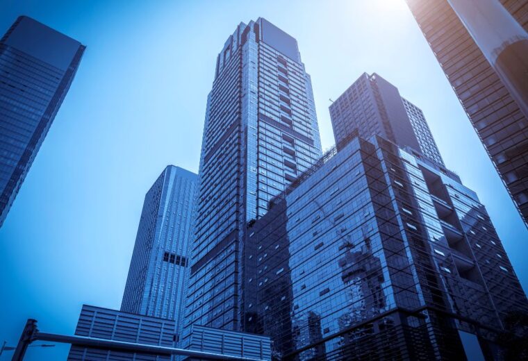 Several high-rise buildings in a pale blue light - Express Capital Financing