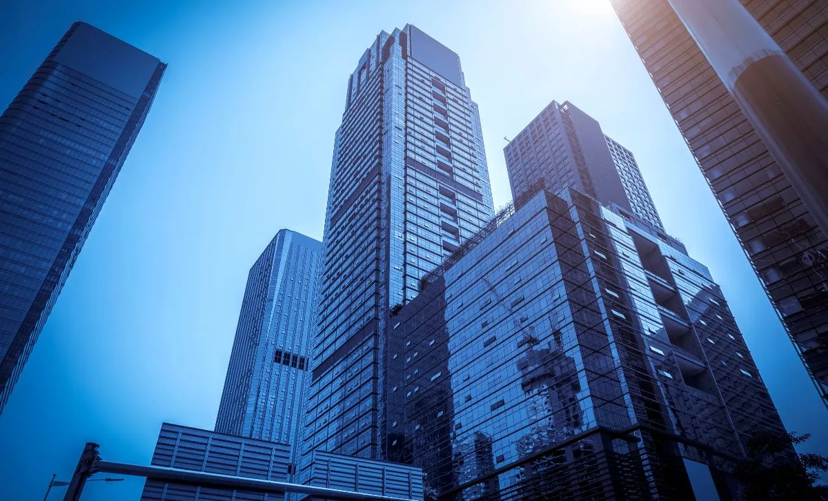 Several high-rise buildings in a pale blue light - Express Capital Financing