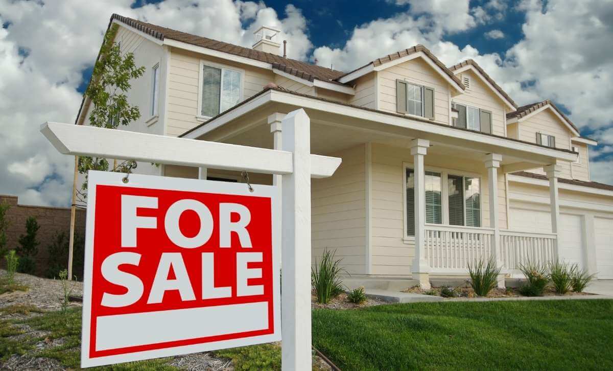 A property with a for sale sign in front after a fix and flip - Fix and flip exit strategies - Express Capital Financing
