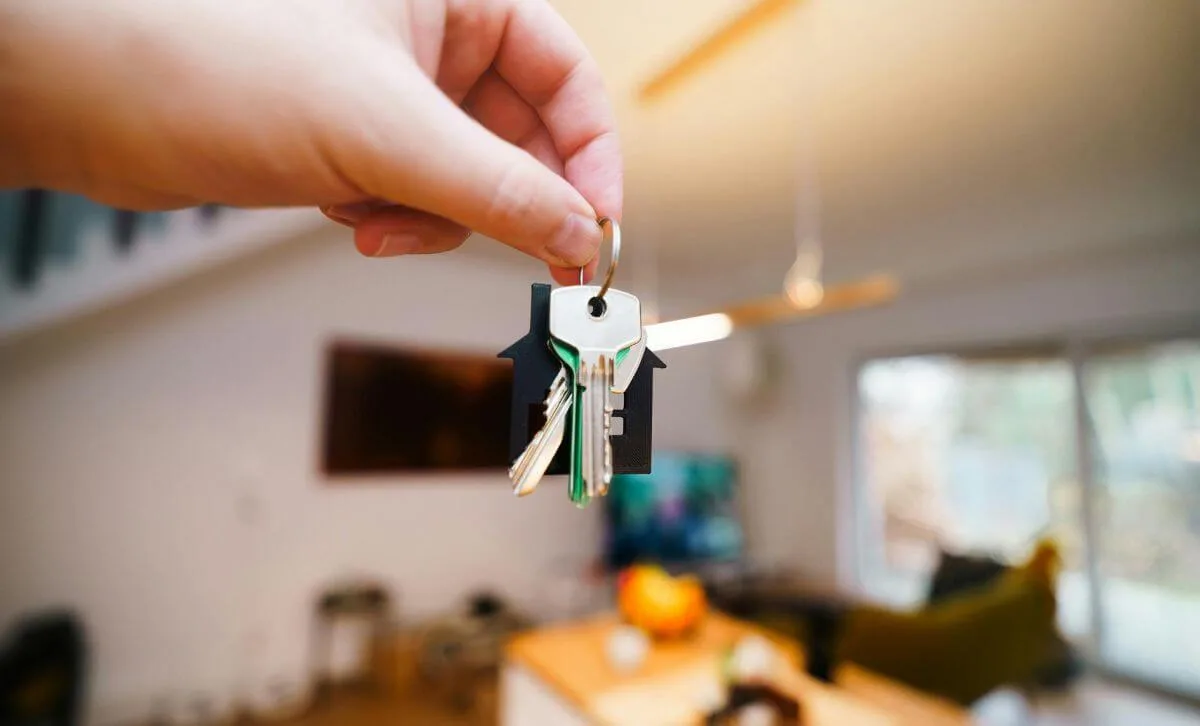 A property investor holding the keys to their new rental property investment - Express Capital Financing