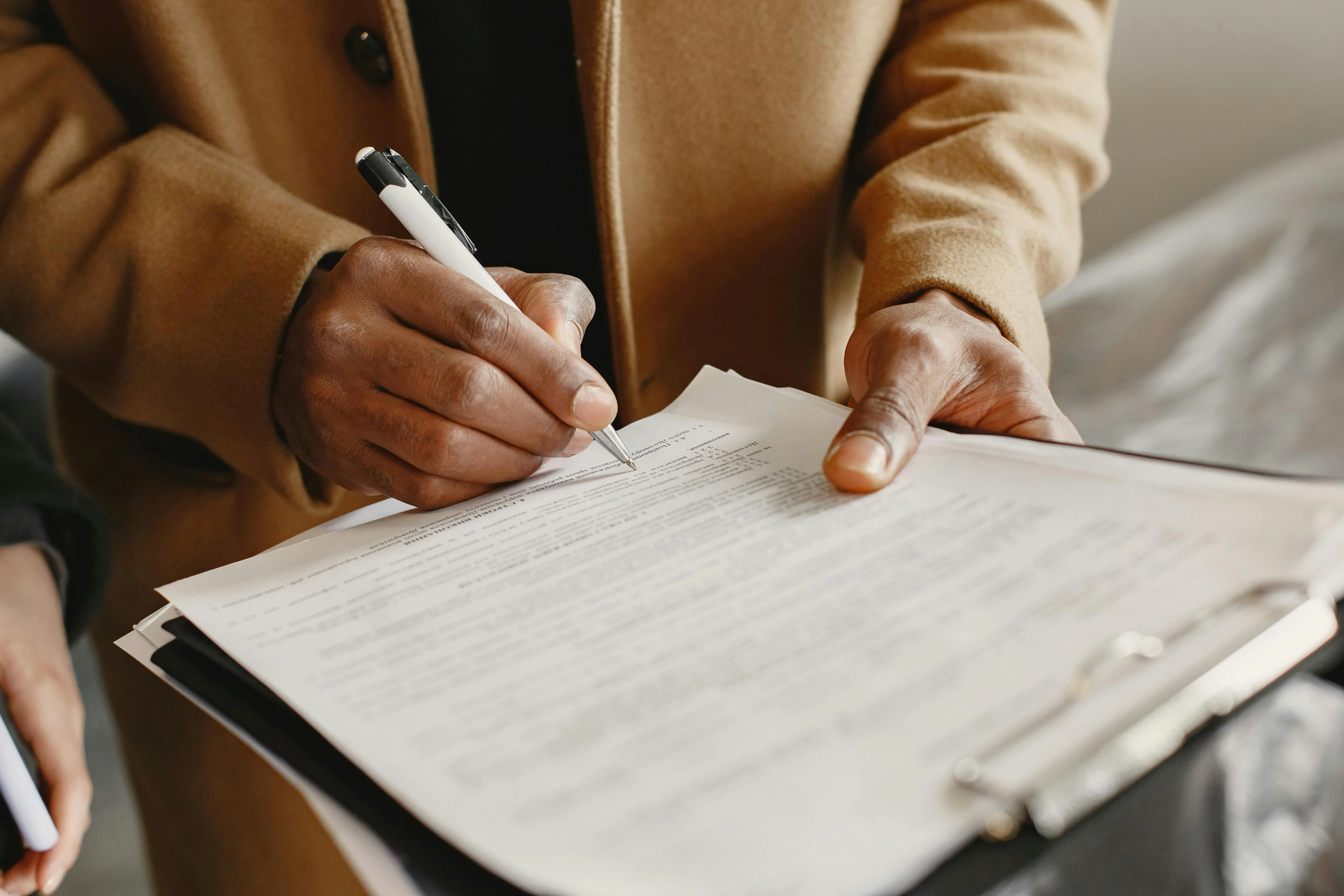A person signing a document - Express Capital Financing